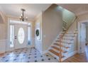 Inviting home entrance with tile flooring, a decorative door, and a staircase at 10 Georgetown Woods Dr, Youngsville, NC 27596