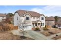 Charming two-story home featuring a two-car garage and a welcoming front porch with brick steps and landscaped garden at 104 Highland Mist Cir, Apex, NC 27539
