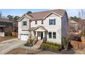 Charming two-story home featuring a two-car garage and a welcoming front porch with brick steps and landscaped garden at 104 Highland Mist Cir, Apex, NC 27539