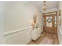 Bright entryway features a wooden front door, chandelier, and decorative accents at 1101 Bessie Ct, Wake Forest, NC 27587