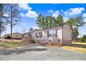 Inviting one-story residence with a charming porch, complemented by a well-manicured lawn and shaded driveway at 112 Mckoy Town Rd, Cameron, NC 28326