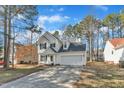 Charming two-story home with a well-manicured lawn and attached two car garage at 112 Wellspring Dr, Holly Springs, NC 27540