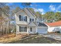 Charming two-story home with a well-manicured lawn and attached two car garage at 112 Wellspring Dr, Holly Springs, NC 27540