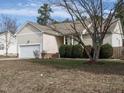 Exterior view of a home, featuring a two-car garage and mature landscaping at 1219 E Middleton Dr, Creedmoor, NC 27522