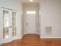 Bright foyer featuring hardwood floors and a view of the front door and French doors at 1219 E Middleton Dr, Creedmoor, NC 27522