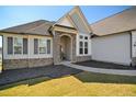 Inviting entrance with stone accents and a well-lit pathway at 156 Bornean Dr, Garner, NC 27529