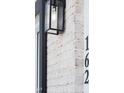 Close-up of the house number and exterior brick wall with modern outdoor lighting at 162 Lookout Rdg # 677, Pittsboro, NC 27312