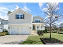 Inviting two-story home with a covered front porch, landscaped yard, and a convenient two-car garage at 200 Gravel Brook Ct, Cary, NC 27519