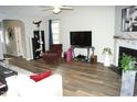 Spacious living room with fireplace, modern flooring, and ample natural light at 2213 Oakhurst Trl, Hillsborough, NC 27278