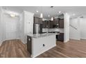 Kitchen featuring granite counters, stainless appliances, and wood flooring at 236 Shingle Oak Rd, Wake Forest, NC 27587