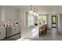 Bright kitchen with a large island, stylish pendant lighting, and modern appliances at 2656 Welham Aly, Raleigh, NC 27608