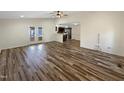 Open-concept living room with hardwood floors, a ceiling fan, and access to the kitchen at 308 Trimble Ave, Cary, NC 27511