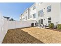 Private backyard featuring a white fence, patio, and a grill, perfect for outdoor entertaining and relaxation at 4918 Neuse Commons Ln, Raleigh, NC 27616