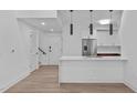 Bright, open-concept kitchen with a breakfast bar and hardwood floors at 615 W Peace St # 406, Raleigh, NC 27605
