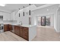 Contemporary kitchen with stainless steel appliances, white countertops, and modern pendant lighting at 615 W Peace St # 406, Raleigh, NC 27605