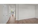 Bright living room with wood-look flooring, and view into the kitchen at 6453 Alfalfa Ln, Wake Forest, NC 27587