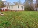 Side yard of home and front porch with stairs at 6508 Treetop Ct, Snow Camp, NC 27349