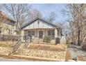 Quaint home with tidy yard, stone retaining walls, a welcoming front porch and driveway access at 723 Holloway St, Durham, NC 27701