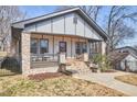 Lovely home featuring stone porch columns, a cozy porch, and appealing curb appeal at 723 Holloway St, Durham, NC 27701