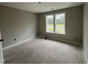 Bright bedroom with two windows letting in ample natural light, ready to be personalized at 73 Grace Pond Ave, Benson, NC 27504