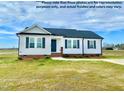 Charming single-story home with gray shutters and a covered front porch on a lush green lawn at 73 Grace Pond Ave, Benson, NC 27504