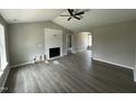 Bright living room with vaulted ceiling, modern fireplace, and stylish flooring at 73 Grace Pond Ave, Benson, NC 27504