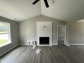 Inviting living room features a vaulted ceiling, modern fireplace, and sleek flooring at 73 Grace Pond Ave, Benson, NC 27504