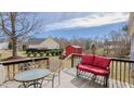 Relaxing back deck featuring outdoor seating and views of the backyard and storage shed at 802 N Fifth St, Mebane, NC 27302