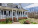 Inviting front porch with white railing and brick steps, perfect for enjoying outdoor relaxation at 802 N Fifth St, Mebane, NC 27302