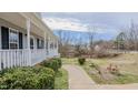 Well-kept front yard with landscaped walkway and established bushes, enhancing curb appeal at 802 N Fifth St, Mebane, NC 27302