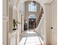 Grand foyer with arched doorways, beautiful tile flooring, and a staircase leading to the upper level at 803 Landuff Ct, Cary, NC 27519