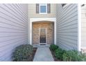 Inviting front entrance with a stone facade and neatly landscaped shrubs at 1009 Laceflower Dr, Durham, NC 27713