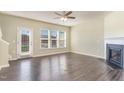 Bright living room with a fireplace, hardwood floors, and large windows at 1009 Laceflower Dr, Durham, NC 27713