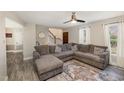 Inviting living room features gray plank flooring, large sectional sofa, and staircase at 104 Tyser Pl, Garner, NC 27529