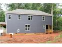 Exterior view of the home features a neutral color and multiple windows offering an abundance of natural light at 105 Sherwood Ln, Hillsborough, NC 27278