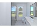 Bright bathroom featuring a walk-in shower, modern vanity, and a window with view to the outdoors at 105 Sherwood Ln, Hillsborough, NC 27278