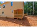 Side view of the two-story home with a covered porch and light yellow exterior paint at 105 Sherwood Ln, Hillsborough, NC 27278