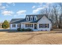 Charming one-story home with classic curb appeal, a covered porch, and well-maintained landscaping at 1309 N Holland Rd, Fuquay Varina, NC 27526