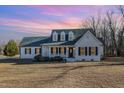 Charming one-story home with classic curb appeal, a covered porch, and well-maintained landscaping at 1309 N Holland Rd, Fuquay Varina, NC 27526