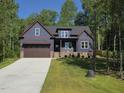 Charming craftsman style home featuring a two-car garage and inviting front porch at 140 Pilot Ridge Rd, Zebulon, NC 27597