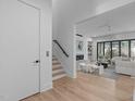 Bright, open-concept living room with hardwood floors and a modern fireplace at 1406 Lyon St # 101, Raleigh, NC 27608