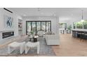 Elegant living room featuring a fireplace, contemporary furniture, and seamless indoor-outdoor flow at 1406 Lyon St # 101, Raleigh, NC 27608