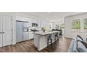 Bright, spacious kitchen features a granite island with seating and stainless steel appliances at 160 Scenic Rock Dr, Youngsville, NC 27596
