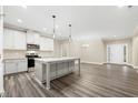 Spacious kitchen features an island with sink, granite countertops and stainless steel appliances at 1985 Meadowview Dr, Graham, NC 27253