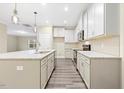 Modern kitchen featuring white cabinets, granite countertops, island and stainless steel appliances at 1985 Meadowview Dr, Graham, NC 27253