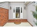 Home front door with decorative sidelights, brick accent wall, and outdoor lanterns at 200 Beachers Brook Ln, Cary, NC 27511