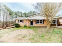 Brick home featuring a well-maintained lawn and mature trees at 2104 Live Oak Dr, Sanford, NC 27330