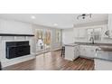 An open kitchen with a fireplace and white cabinetry at 2232 Miller Rd, Hillsborough, NC 27278