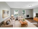 Bright, neutrally decorated living room boasts large windows and ample seating area at 26 Malbry Pl, Durham, NC 27704