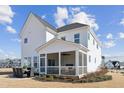 Rear exterior view showcasing a charming two-story home with screened in porch at 2644 Catheys Creek Cir, Wendell, NC 27591
